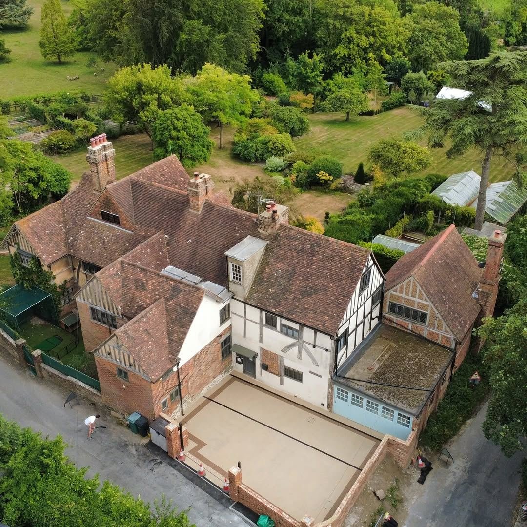 Aerial view of a Grade II listed timber-framed house with a new resin driveway