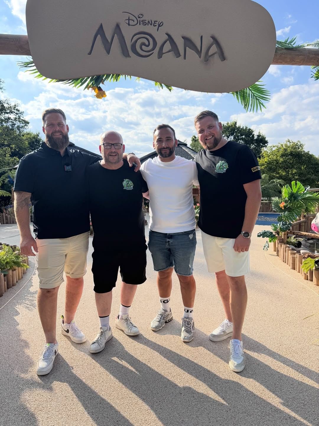 Four of the S2S crew in branded tees under the Moana sign