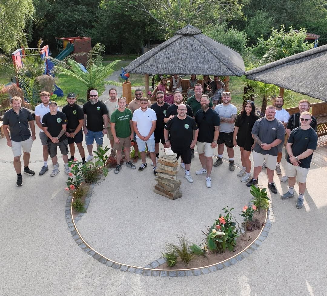 Volunteer tradespeople gathered in the finished Little Havens garden