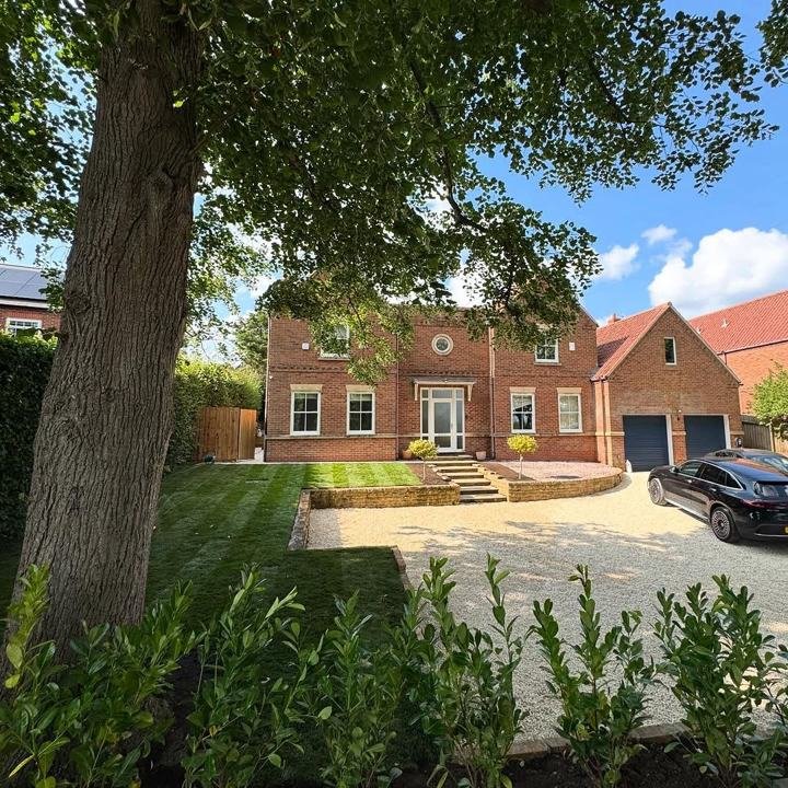 Front garden with gravel drive, steps and raised lawn