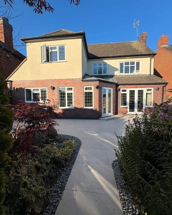 Rear garden path and planting behind a large family home