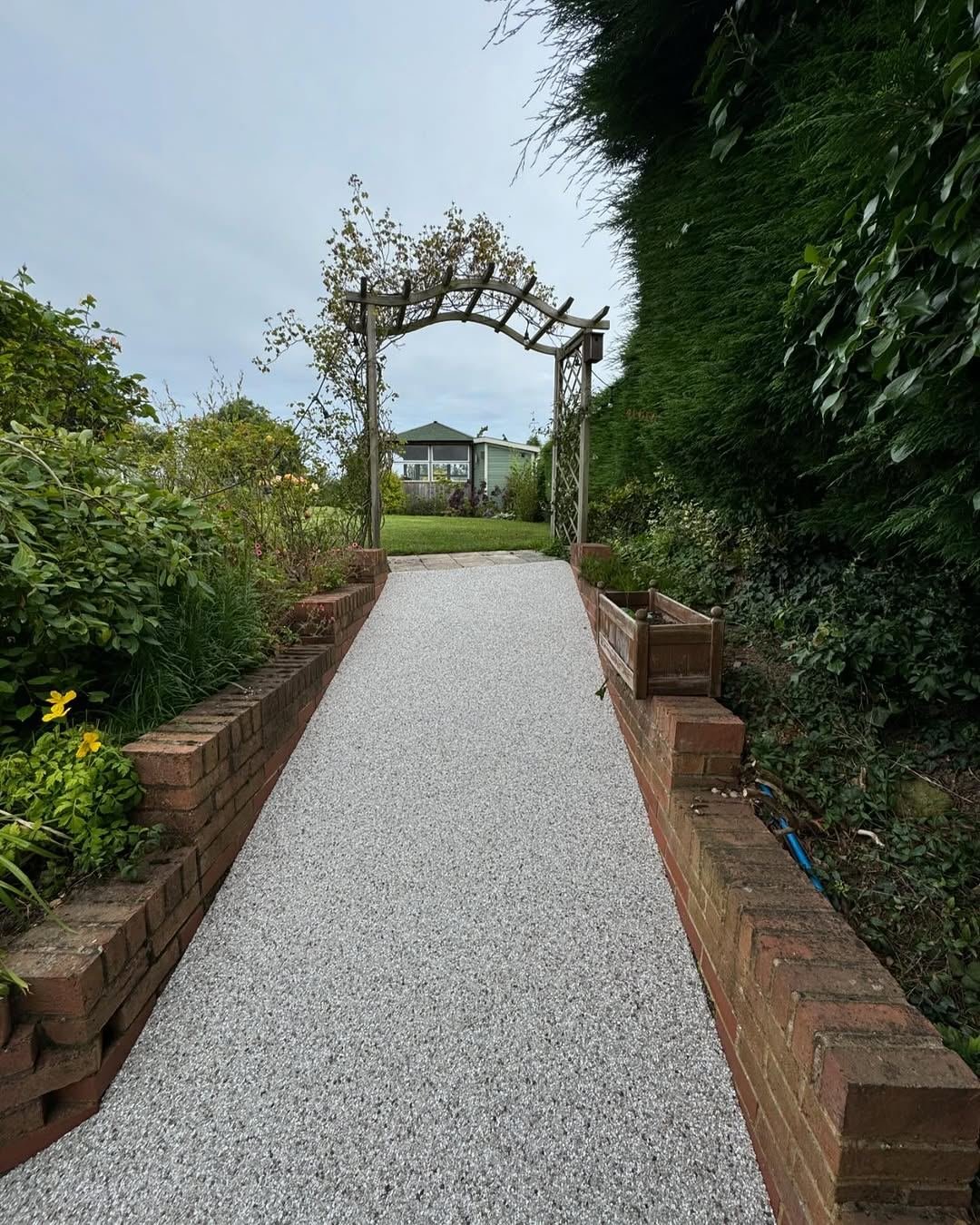 Finished resin path through a garden arch