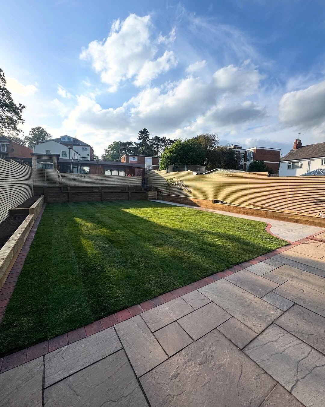 Level lawn and paving in a garden that was once three tiers
